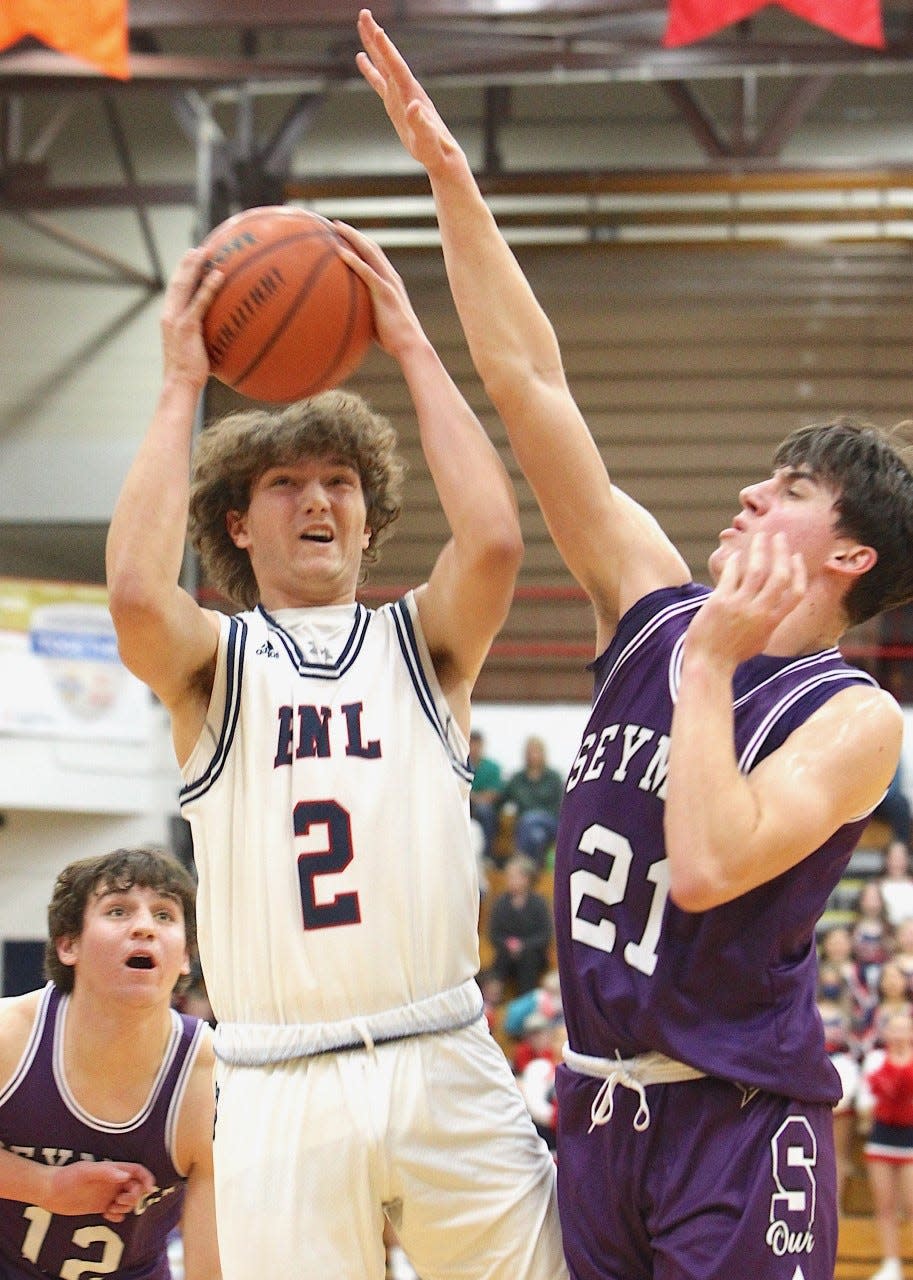 BNL's Colten Leach (2) goes up against tight defense from Seymour's Casey Regruth Friday night at BNL Fieldhouse.