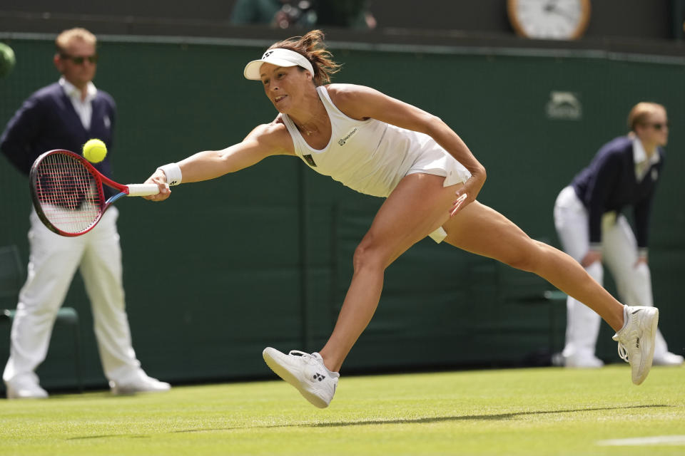 Germany's Tatjana Maria returns the ball to Latvia's Jelena Ostapenko during a fourth round women's singles match on day seven of the Wimbledon tennis championships in London, Sunday, July 3, 2022. (AP Photo/Alberto Pezzali)