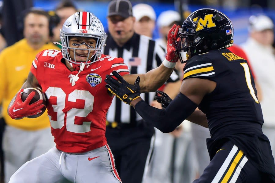 ARLINGTON, TEXAS – DECEMBER 29: TreVeyon Henderson #32 of the Ohio State Buckeyes runs the ball against Jaylon Carlies #1 of the Missouri Tigers during the first quarter in the Goodyear Cotton Bowl at AT&T Stadium on December 29, 2023 in Arlington, Texas. (Photo by Ron Jenkins/Getty Images)