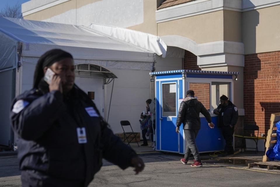 People walk in and out of a tent shelter built for migrants in the parking lot of an old CVS store, Thursday, Feb. 1, 2024, in the Little Village neighborhood of Chicago. (AP Photo/Erin Hooley) oley)
