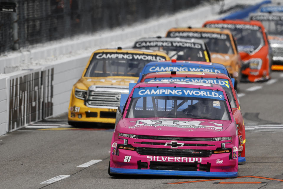 Driver Zane Smith (21) leads the field during the NASCAR Truck Series race on Saturday, Oct. 30, 2021, in Martinsville, Va. (AP Photo/Wade Payne)