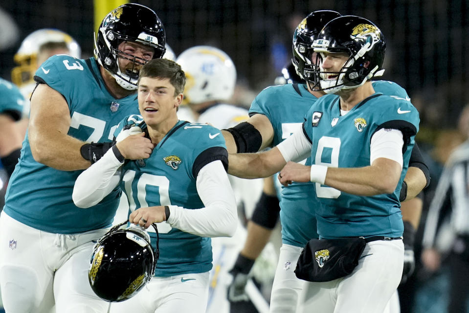 Jacksonville Jaguars place kicker Riley Patterson (10) and his team celebrate his game-winning field goal against the Los Angeles Chargers during the second of an NFL wild-card football game, Saturday, Jan. 14, 2023, in Jacksonville, Fla. Jacksonville Jaguars won 31-30. (AP Photo/John Raoux)