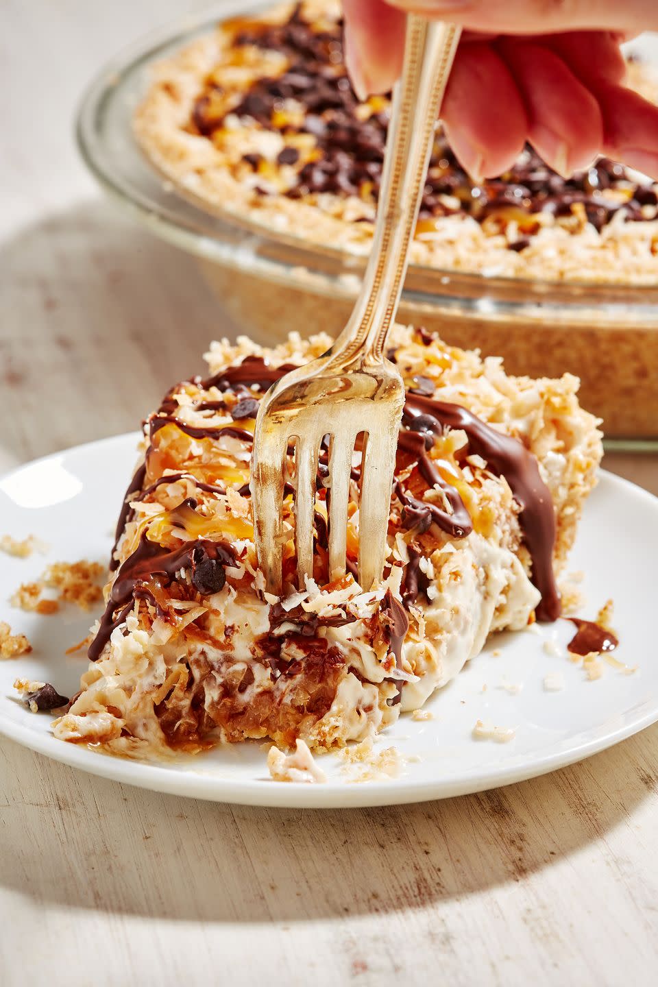 frozen samoa pie on a white plate with a fork and a bite missing