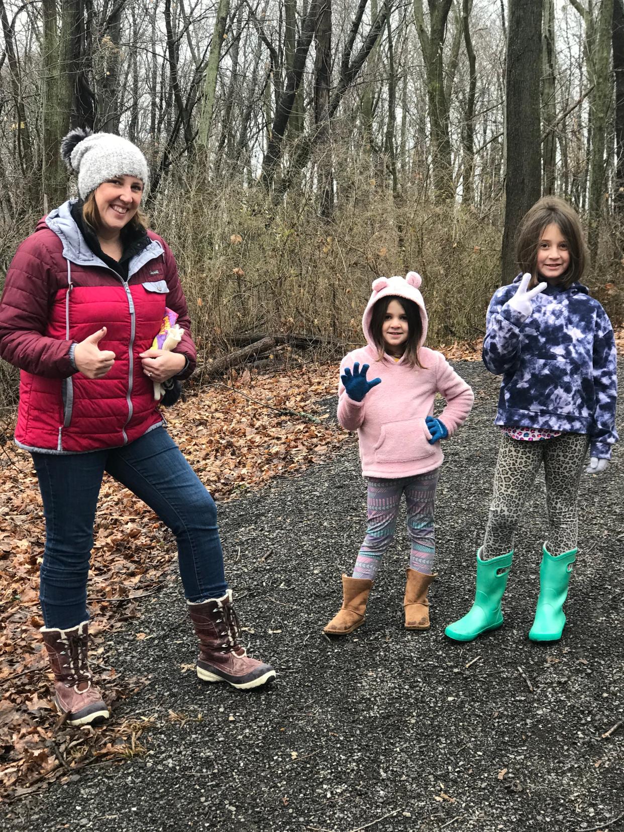 Jannah Wilson, the new executive director of the Ottawa County Park District, walks along one of the new trails which doubles as somewhat of her workspace with her two daughters, Eva Wilson, middle, and Avery Wilson, right.