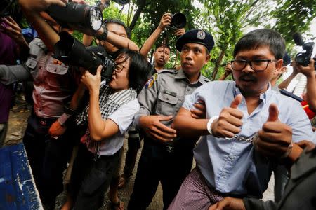 Detained Reuters journalist Wa Lone is escorted by police while leaving Insein court in Yangon, Myanmar July 9, 2018. REUTERS/Ann Wang