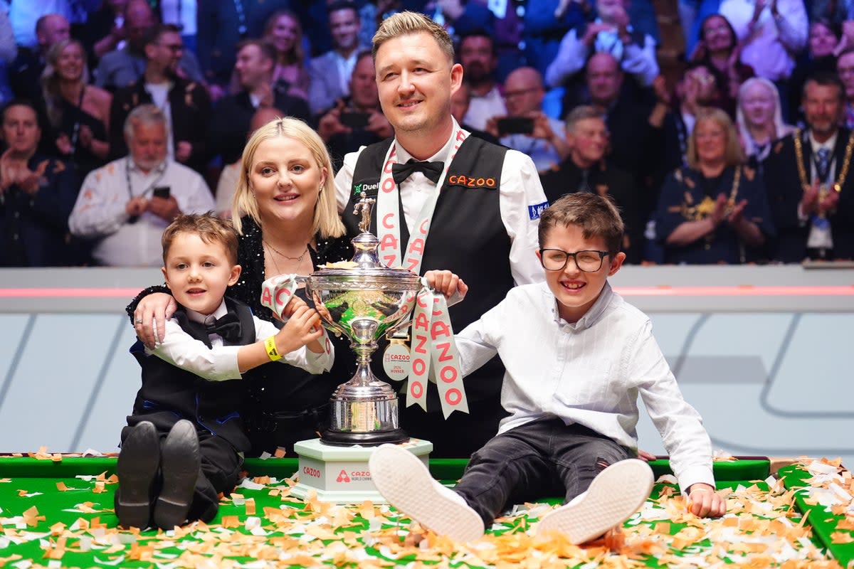 Kyren Wilson celebrates with his wife Sofie and children Finley and Bailey (PA)
