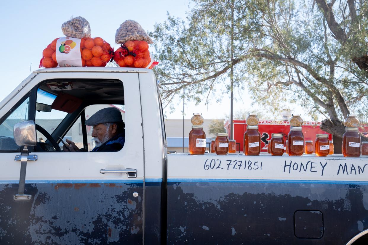 Antonio Recoba waits for customers on Jan. 18, 2024, on Miller Road in Buckeye. Recoba moved his honey stand from state-owned land in Rainbow Valley after complaints and has noticed a slight slowdown in business.