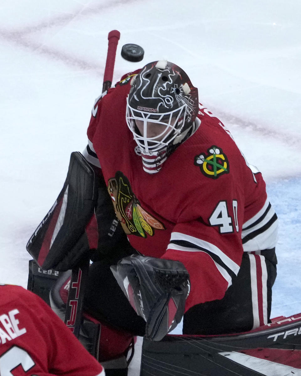 The puck flies over the head of Chicago Blackhawks goaltender Arvid Soderblom during the first period of an NHL hockey game against the St. Louis Blues Wednesday, Nov. 16, 2022, in Chicago. (AP Photo/Charles Rex Arbogast)
