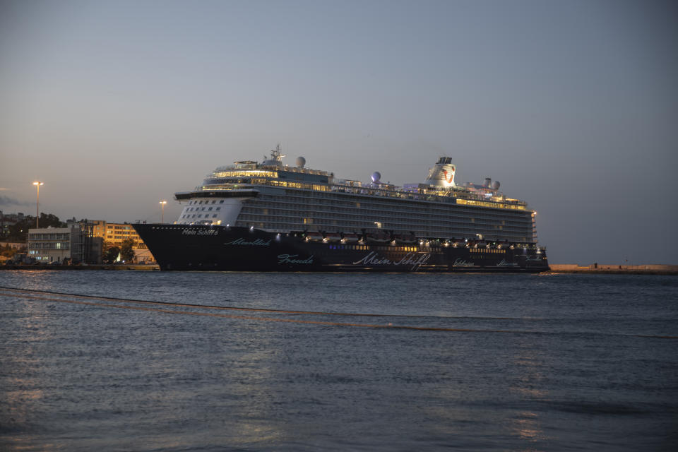 The Mein Schiff 6 cruise ship is docked at Piraeus port, near Athens, early Tuesday, Sept. 29, 2020. Greek authorities say 12 crew members on a Maltese-flagged cruise ship carrying more than 1,500 people on a Greek islands tour have tested positive for coronavirus and have been isolated on board. (AP Photo/Petros Giannakouris)