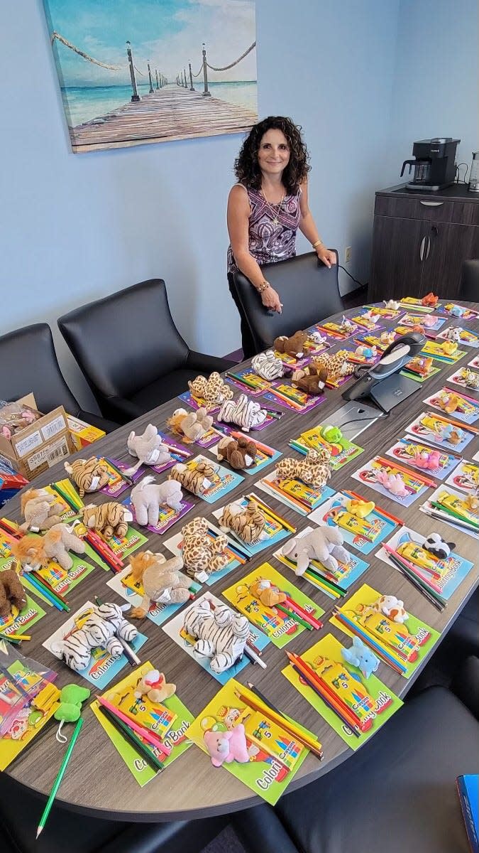 Women Aware’s Domestic Violence Response Team (DVRT) Administrator is Anna Andrade poses with comfort kits for children. The state-designated lead domestic violence agency for Middlesex County, Women Aware moves approximately 2,000 survivors beyond abuse each year.