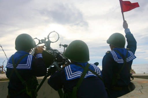 Vietnamese sailors train with a 12.7 mm machine gun on Phan Vinh Island in the Spratly archipelago on June 14, 2011. Tensions flared in May when Vietnam said Chinese marine surveillance vessels cut the exploration cables of an oil survey ship inside the country's exclusive economic zone