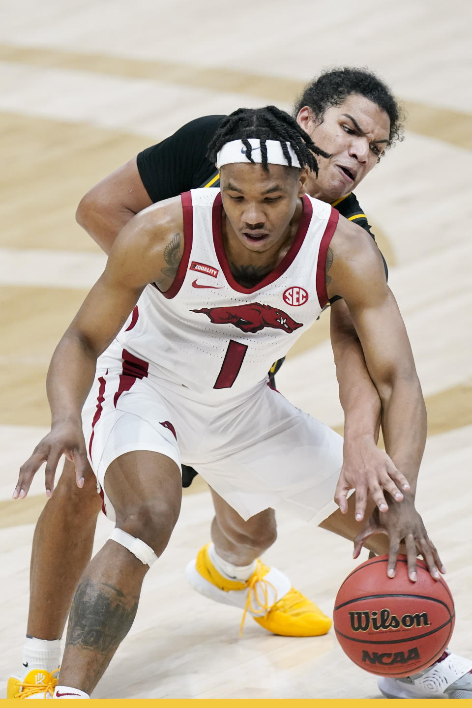 Missouri's Dru Smith, top, defends against Arkansas' JD Notae (1) in the first half of an NCAA college basketball game in the Southeastern Conference Tournament Friday, March 12, 2021, in Nashville, Tenn. (AP Photo/Mark Humphrey)