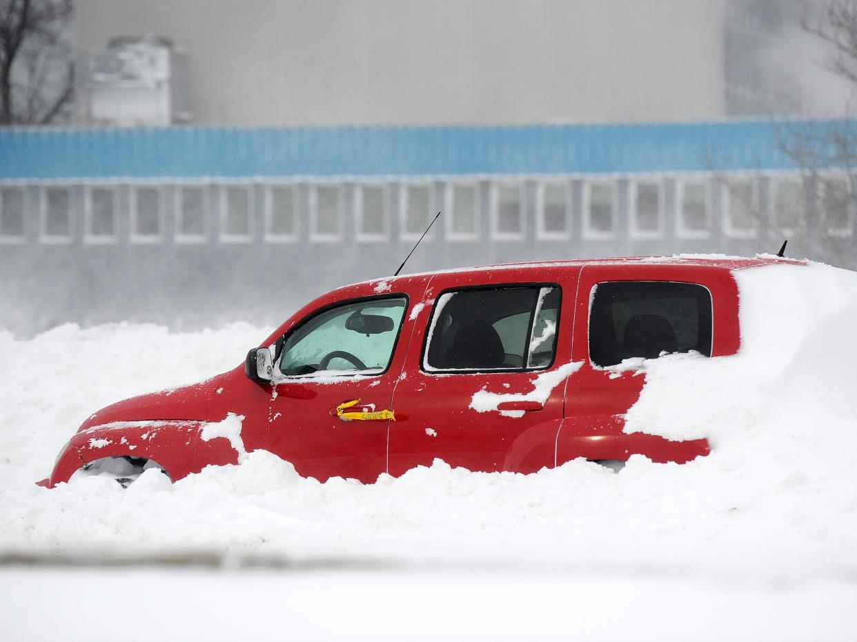 Ice and snow cover an abandoned vehicle along the Lake Erie shoreline on December 24, 2022 in Hamburg, New York.