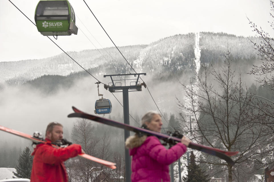 Skiers walk away from Silver Mountain after an avalanche after an avalanche killed multiple people and injured others on Tuesday, Jan. 7, 2020, in Kellogg, Idaho. (Kathy Plonka/The Spokesman-Review via AP)