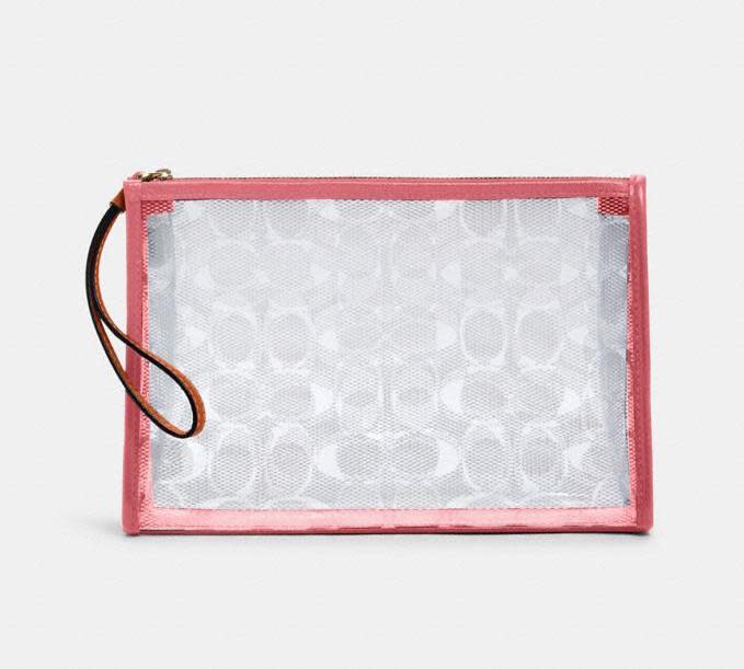 Beach Clutch In Signature Clear Canvas. Image via Coach Outlet.