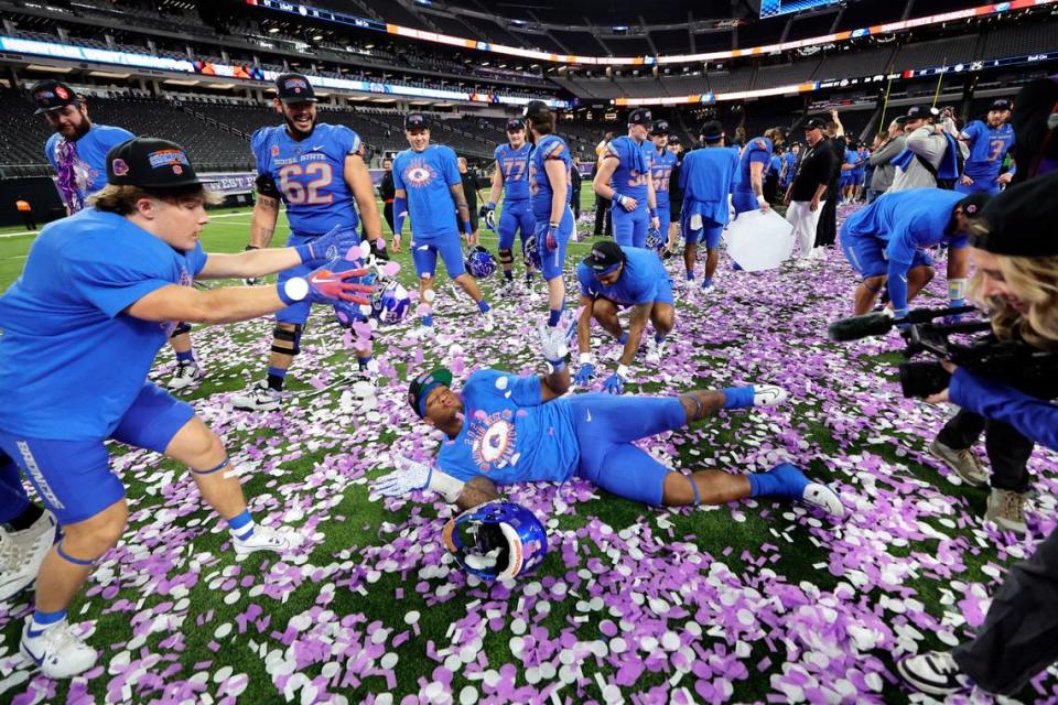 Boise State defensive end Cortez Hogans, center, plays in confetti after the Broncos’ 44-20 win over UNLV in the Mountain West championship game Saturday at Allegiant Stadium.