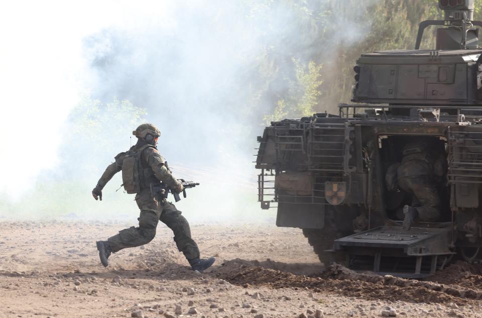 A Bundeswehr soldier runs towards a Puma mechanized infantry combat vehicle during a demonstration of capabilities by the Panzerlehrbrigade 9 tank training brigade on June 02, 2021 in Munster, Germany. Germany has steadily increased its defense spending in recent years, to a record EUR 53 billion slated for 2021 (Getty Images)