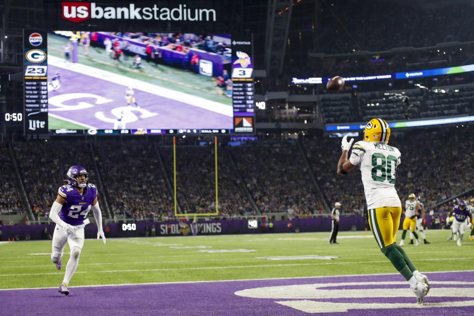 Green Bay Packers' Bo Melton catches a touchdown pass during the second half of an NFL football game against the Minnesota Vikings Sunday, Dec. 31, 2023, in Minneapolis. (AP Photo/Bruce Kluckhohn)
