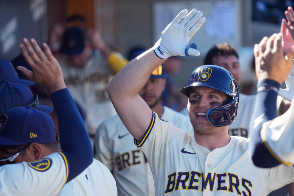 Outfielder Brewer Hicklen celebrates with teammates in the Brewers dugout after hitting a solo home run in the eighth inning against the Padres on Friday.