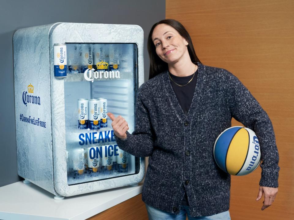 Sue Bird poses with the Corona Fine Life Fridge.