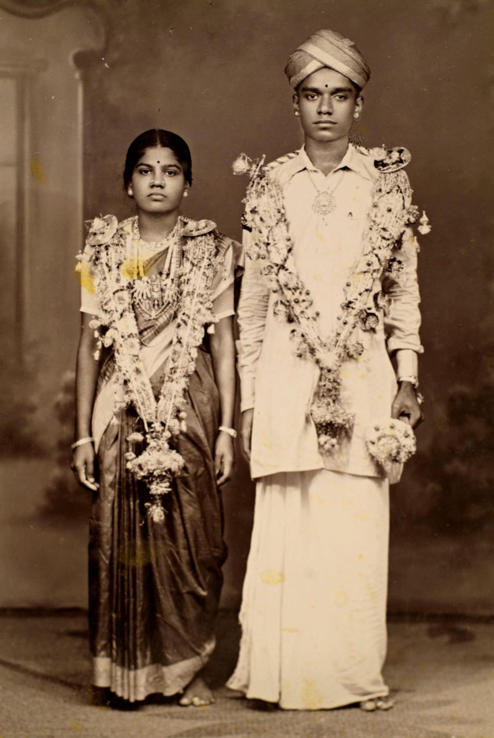 A family photograph of two Chettians wearing cultural garb.