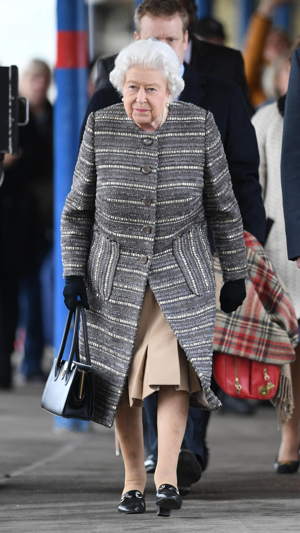 The Queen kept warm in a grey boucle coat [Photo: PA]