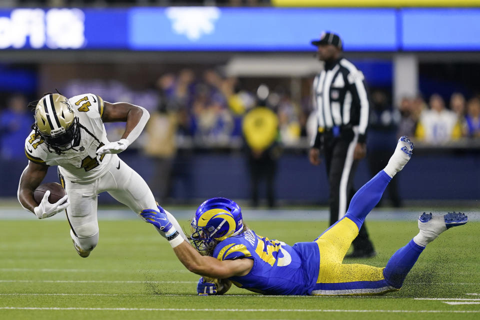 New Orleans Saints running back Alvin Kamara (41) is tackled by Los Angeles Rams linebacker Christian Rozeboom (56) during the first half of an NFL football game Thursday, Dec. 21, 2023, in Inglewood, Calif. (AP Photo/Ryan Sun)