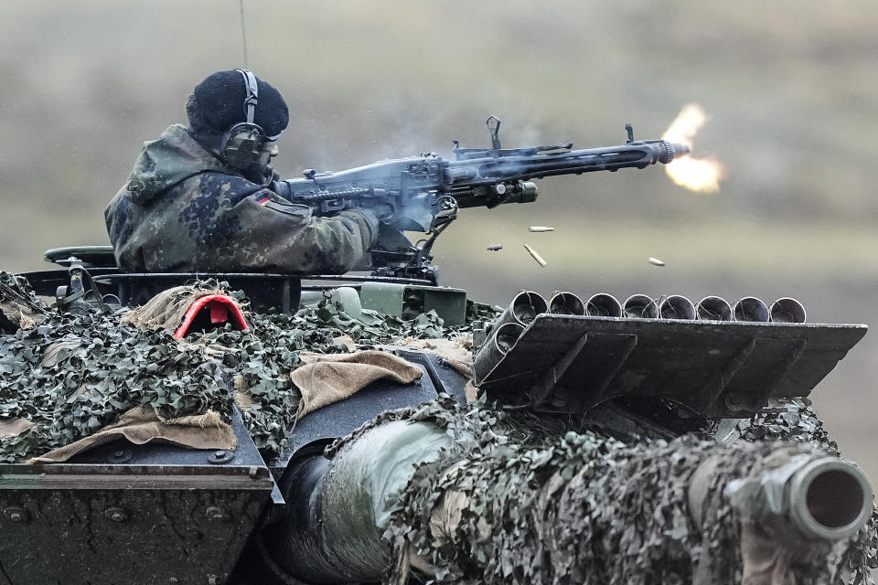 FILE - A soldier fires a machine gun from a Leopard 2 tank at the Bundeswehr tank battalion 203 at the Field Marshal Rommel Barracks in Augustdorf, Germany, Wednesday, Feb. 1, 2023. An independent Sweden-based watchdog says the world military spending has grown for the eighth consecutive year in 2022 to an all-time high of $2240 billion leading to a sharp rise of 13% taking place in Europe, chiefly due to Russian and Ukrainian expenditure. (AP Photo/Martin Meissner, File )