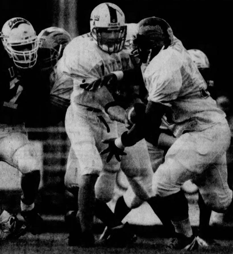 Dunellen QB and Snapple Bowl MVP Luke Ciannello hands off to South Brunswick’s Ahmeel Kirton, right, as the Middlesex County all-stars rolled Thursday, July 16, 1998, 33-7, over Union County.