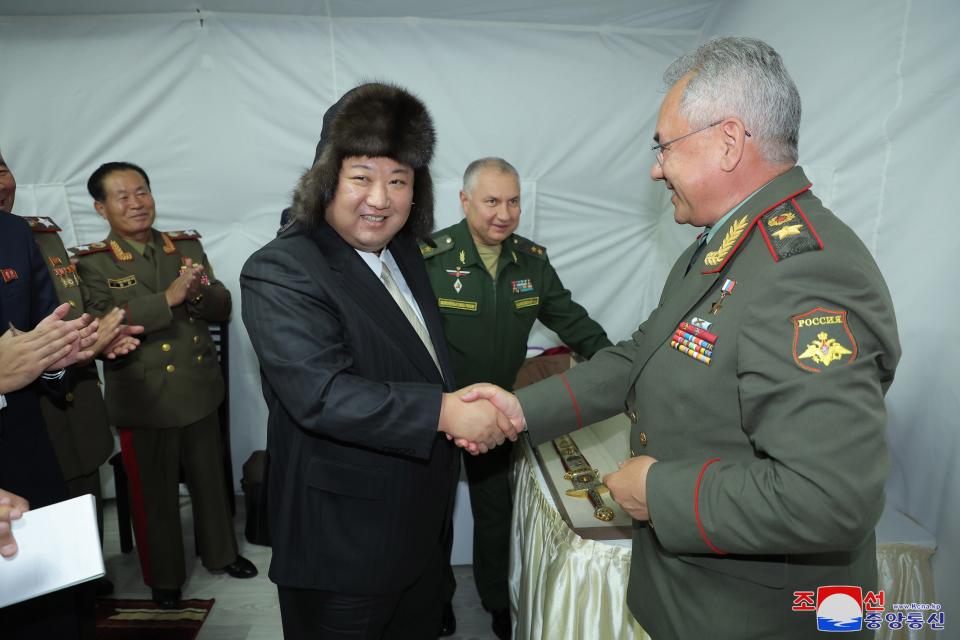 North Korean leader Kim Jong-un (C) shaking hands with Russian defence minister Sergei Shoigu (R) during a visit to Vladivostok (EPA)