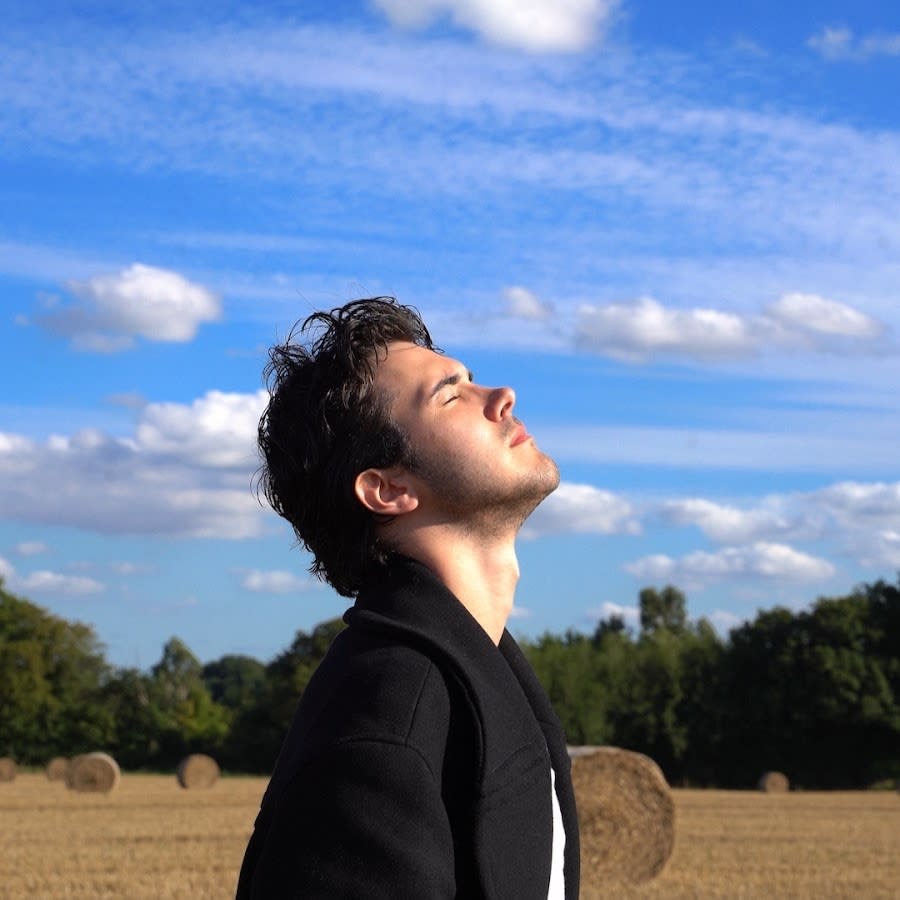 Singer Jack Kane with his eyes closed and head turned to the sky