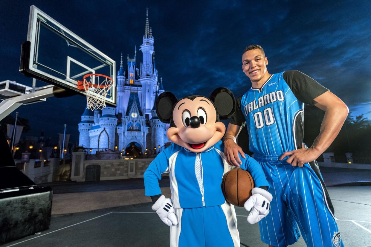 Aaron Gordon poses with an undersized forward in front of a castle. (Matt Stroshane/Walt Disney World)