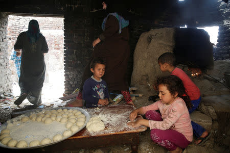 A family prepares bread at their house in Egypt's Nile Delta village of El Shakhluba, in the province of Kafr el-Sheikh, Egypt May 5, 2019. Picture taken May 5, 2019. REUTERS/Hayam Adel
