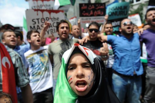 Demonstrators protest against Syrian President Bashar al-Assad in front of the Syrian consulate in Istanbul on May 27. The UN's top observer said on Wednesday he was "deeply disturbed" by a newly discovered massacre in Syria, as the opposition insisted President Bashar al-Assad must step down if a peace plan is to be saved