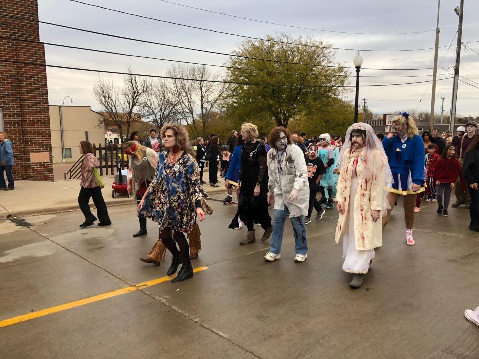 A group of people participates in the Sioux Falls Zombie Walk in downtown Sioux Falls on Saturday, Oct. 27, 2018.