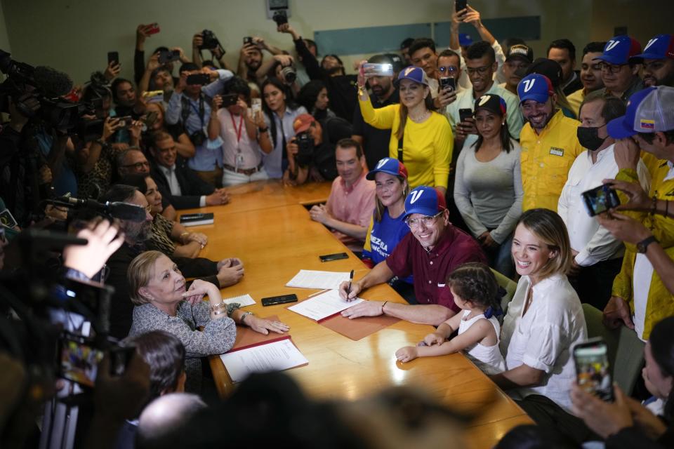 FILE - Opposition leader Henrique Capriles, center right, sitting, smiles after registering his candidacy in the opposition's upcoming primary election, in Caracas, Venezuela, June 24, 2023. (AP Photo/Matias Delacroix, File)