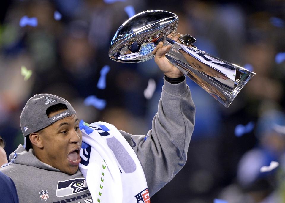 Seattle Seahawks' Malcolm Smith celebrates with the Vince Lombardi Trophy after the NFL Super Bowl XLVIII football game against the Denver Broncos Sunday, Feb. 2, 2014, in East Rutherford, N.J. The Seahawks won 43-8. (AP Photo/Bill Kostroun)