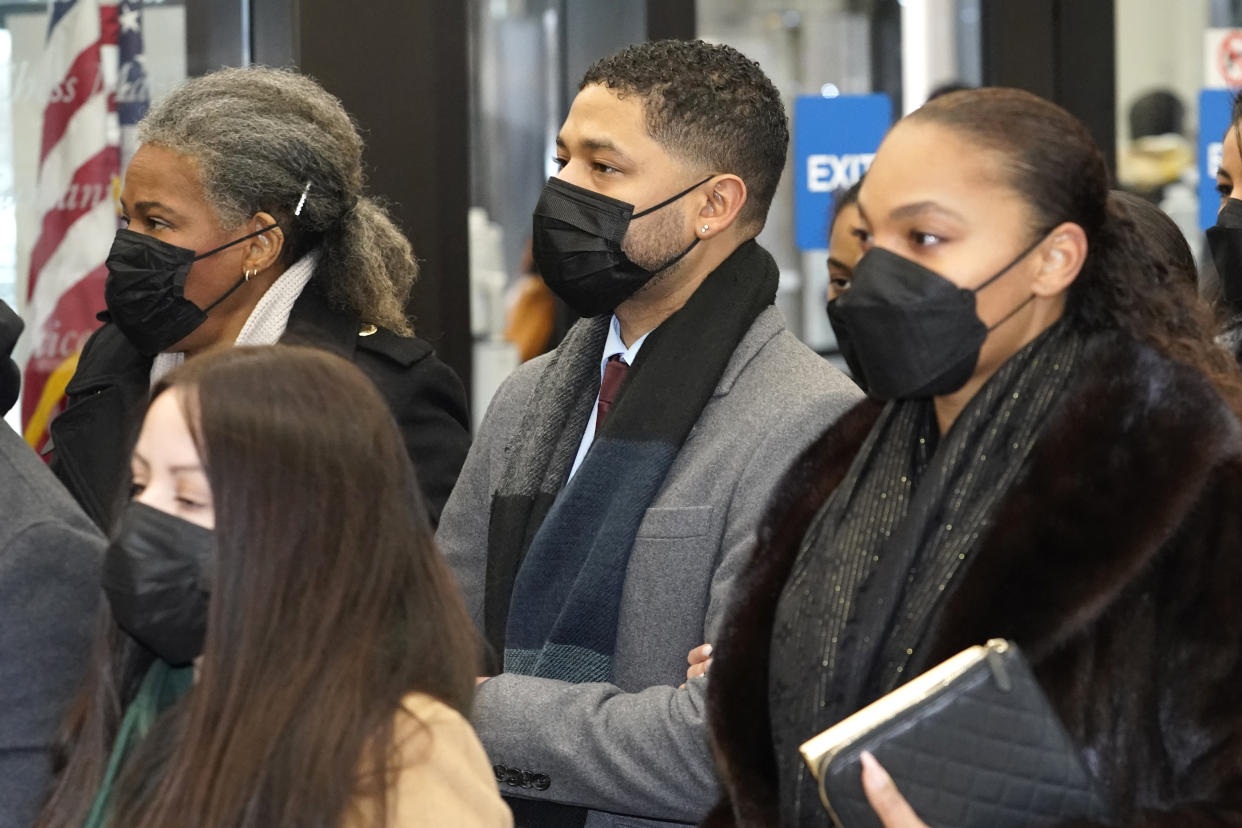 Actor Jussie Smollett, center, arrives with his mother Janet, left, Monday, Dec. 6, 2021, at the Leighton Criminal Courthouse for day five of his trial in Chicago. Smollett is accused of lying to police when he reported he was the victim of a racist, anti-gay attack in downtown Chicago nearly three years ago, in Chicago. (AP Photo/Charles Rex Arbogast)