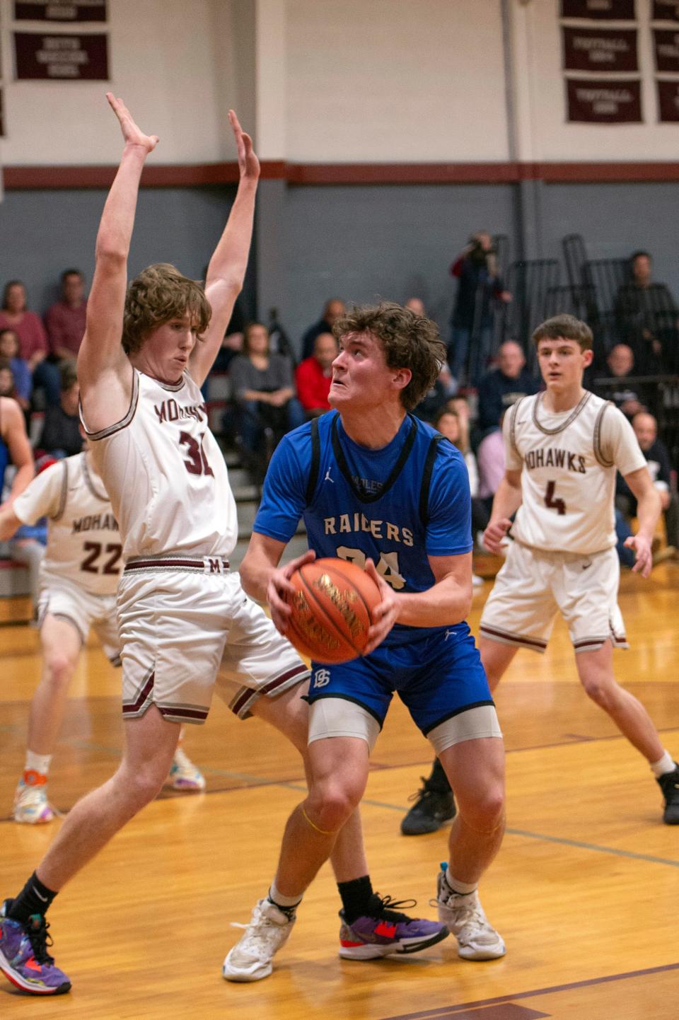 Dover-Sherborn junior captain Brian Olson eyes the basket, as Millis High junior captain Adam Hart pressures, during the game in Millis, Jan. 31, 2023. The Raiders defeated the Mohawks, 75-60.