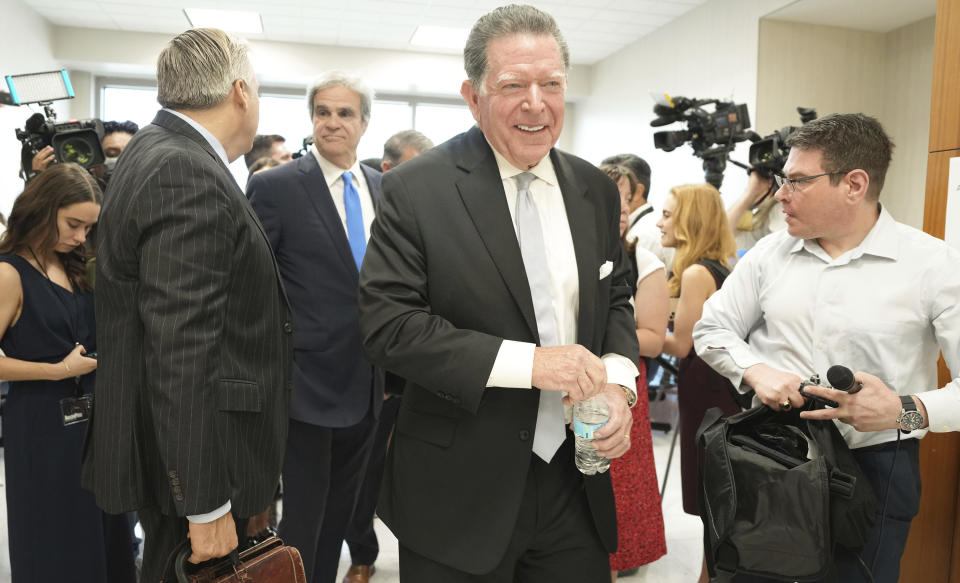 Dan Cogdell, defense attorney for suspended Texas Attorney General Ken Paxton, leaves a media scrum after a court appearance at Harris County Courthouse on Thursday, Aug. 3, 2023 in Houston. Embattled Texas Attorney General Ken Paxton's years-delayed trial on securities fraud charges will have to wait until his separate impeachment trial is concluded, lawyers and the judge in the case said Thursday. (Elizabeth Conley/Houston Chronicle via AP)