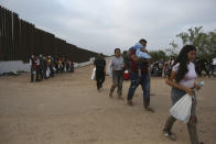 Migrants who had crossed the Rio Grande river into the United States are taken away by U.S. Border Patrol agents in Eagle Pass, Texas, Friday, May 20, 2022. As U.S. officials anxiously waited, many of the migrants crossing the border from Mexico on Friday were oblivious to a pending momentous court ruling on whether to maintain pandemic-related powers that deny a chance to seek asylum on grounds of preventing the spread of COVID-19. (AP Photo/Dario Lopez-Mills)