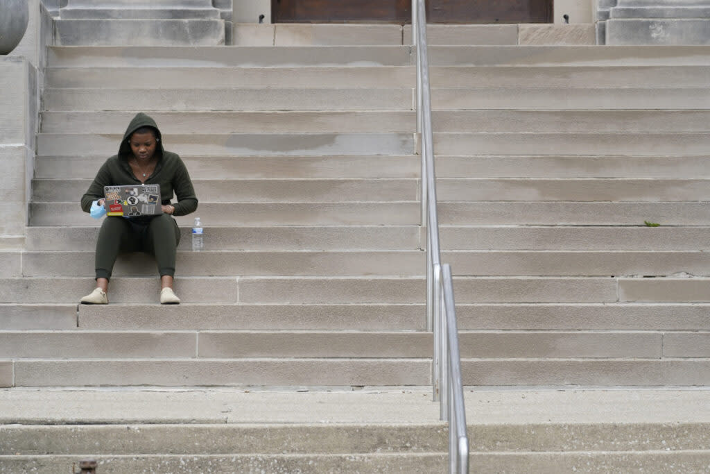 A student studies on the Indiana University campus in Bloomington, Ind. Some states are considering bills requiring public colleges to publish course materials’ titles and costs. (Photo by Darron Cummings/The Associated Press)