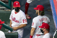 Philadelphia Phillies manager Joe Girardi, left, talks with Bryce Harper, right, prior to a baseball game against the Miami Marlins, Friday, July 24, 2020, in Philadelphia. (AP Photo/Chris Szagola)