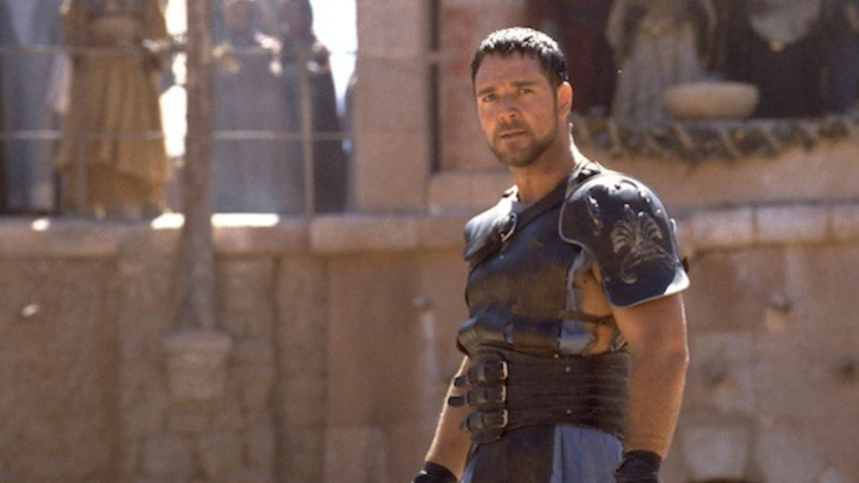  Russell Crowe standing in a gladiator pit in Gladiator 