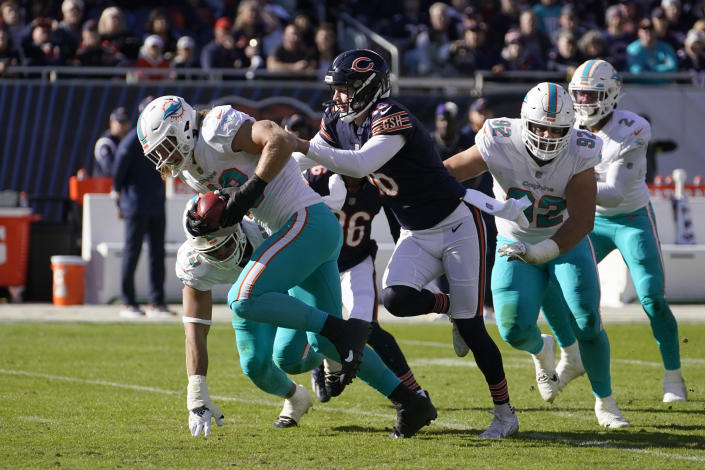 Miami Dolphins linebacker Andrew Van Ginkel runs in a touch down after linebacker Jaelan Phillips, left rear, blocked a kick by Chicago Bears punter Trenton Gill, third from left, during the first half of an NFL football game, Sunday, Nov. 6, 2022 in Chicago. (AP Photo/Charles Rex Arbogast)