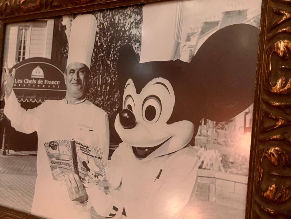 Black and white photo of Monsieur Paul and Mickey Mouse.