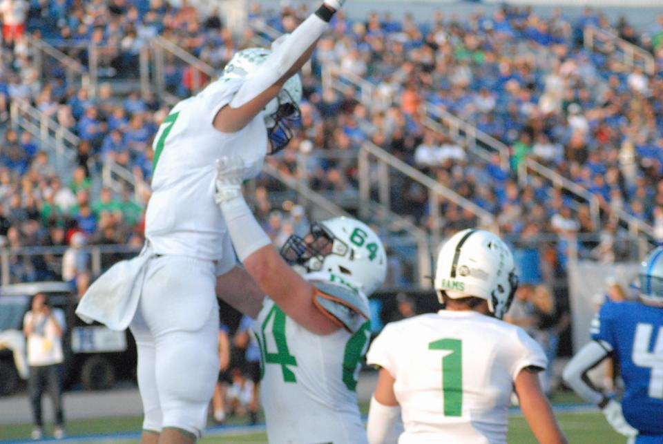 Badin's Zach Yordy (7) is hoisted up by teammate Drew Vocke (64) after scoring a touchdown against Hamilton Friday, Aug. 18, 2023.