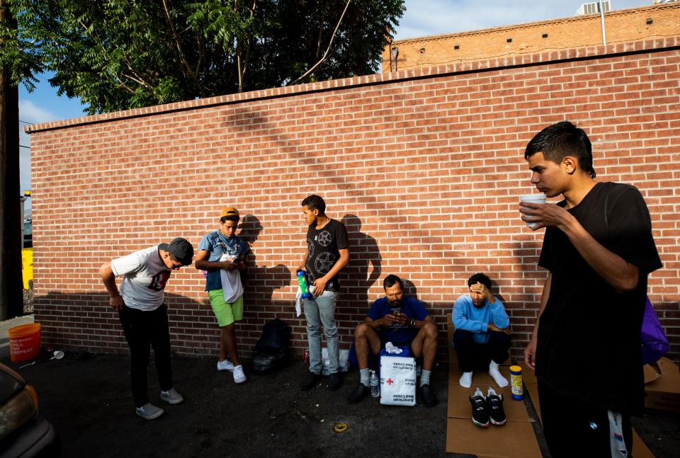 Migrants wait outside of Sacred Heart Church on the morning of Sept,. 13, 2023. The migrants have been arriving in larger numbers in the last two weeks.