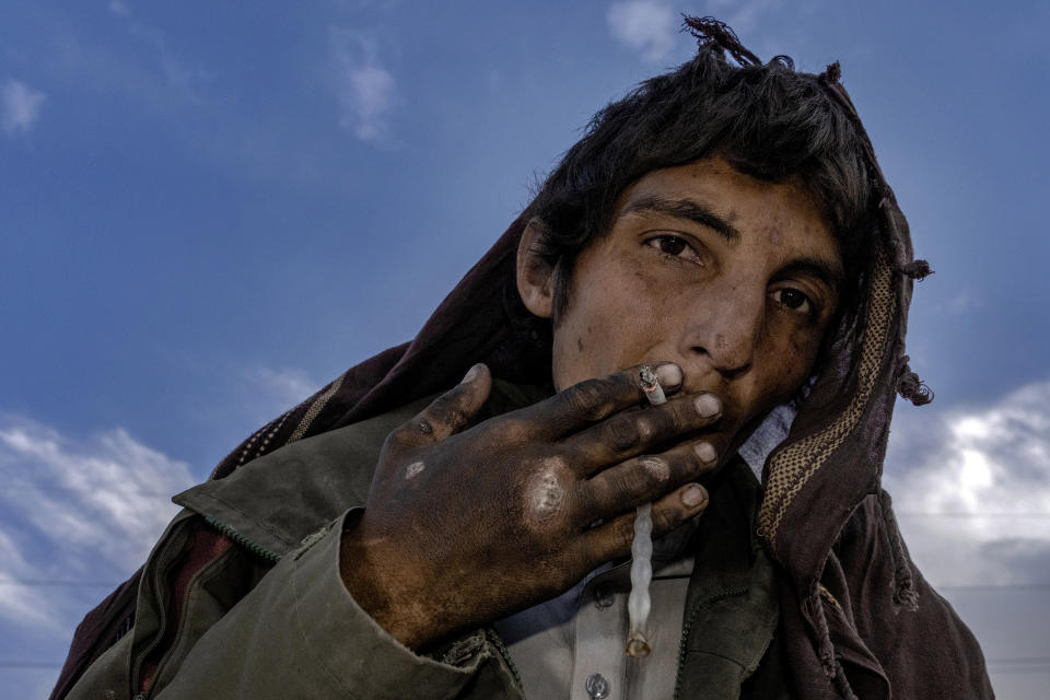 An Afghan drug addict smokes heroin on the edge of a hill in the city of Kabul, Afghanistan,Thursday, June 9, 2022. Drug addiction has long been a problem in Afghanistan, the world’s biggest producer of opium and heroin. The ranks of the addicted have been fueled by persistent poverty and by decades of war that left few families unscarred. (AP Photo/Ebrahim Noroozi)