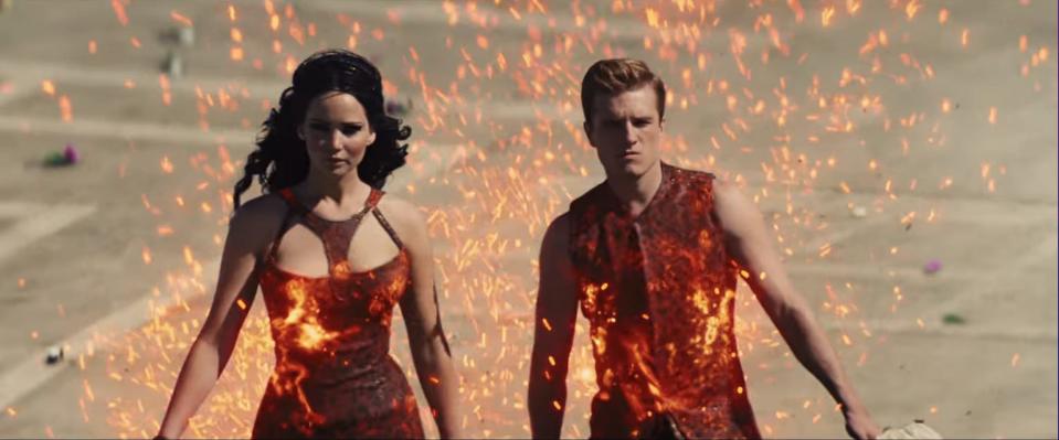 Jennifer Lawrence and Josh Hutcherson in fiery outfits in "The Hunger Games: Catching Fire."